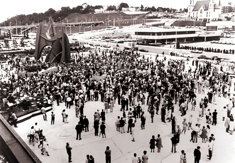 Brids-eye view of the open area with Calder's monumental sculpture in the upper right hand and a large crowd filling the plaza.