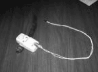 Photograph of bed alarm with tether.