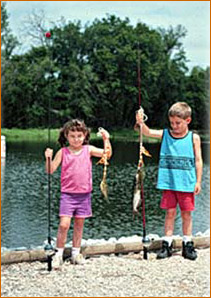 two children showing fish catch