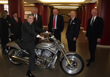 Gutierrez on Harley-Davidson motorcycle surrounded by other U.S. officials in China.