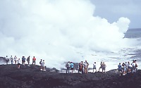 People watching lava pour into sea, Kilauea Volcano, Hawai`i