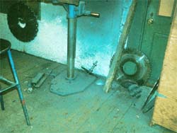 Dust on floor and wall from saw blade sharpening.