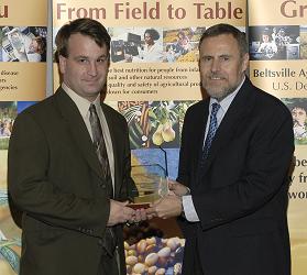 photo of Dr. Mike Cosh (left) accepting 2008 Beltsville Area Early Career Scientist of the Year award.