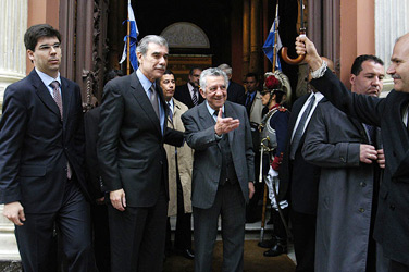 Uruguay’s Foreign Minister Reinaldo Gargano (center) greets Secretary of Commerce Carlos M. Gutierrez (second from left) at the entrance to the foreign ministry building in Montevideo on October 9. During the visit, Gutierrez signed a letter of intent that pledges the two countries to cooperate on issues of innovation and competitiveness.
