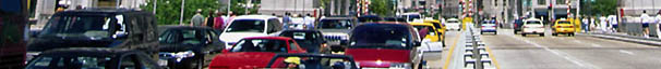 time-lapse photo of traffic traveling in both directions on an urban arterial road