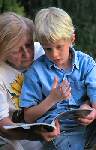 Image of woman reading a book with a child