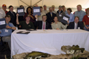 Secretary Carlos Gutierrez joins others to sign the National Fish Habitat Action Plan