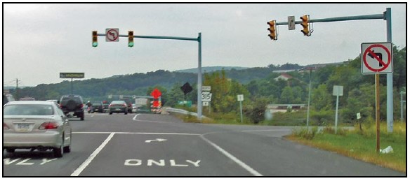 Photo of signalized intersection with two dedicated right turn only lanes. Signs indicate no left turn at this intersection.