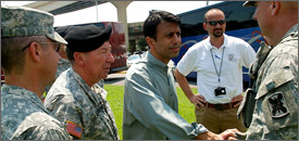 Louisiana Gov. Bobby Jindal, center, shakes hands with U.S. Army Col. Jonathan Ball, commander of the Louisiana National Guard's 256th Brigade Combat team, in New Orleans, Aug. 30, 2008.