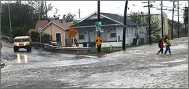 Members of the Louisiana National Guard set up a road block in the upper 9th Ward of New Orleans as water in the Industrial Canal starts to overtop the levees and pour into the city, Sept. 1, 2008.