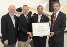 Pictured holding the award are are Rep. Oberstar, Roger Reinhert, President, Duluth City Council; Assistant Secretary Baruah; and Tom Cotruvo, Executive Director, The Desert Alliance for Community Empowerment. Click for larger image.