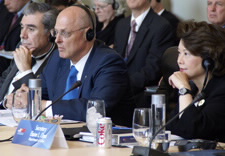 Secretaries Gutierrez, Paulson and Chou seated at table with earphones. Click for larger image.