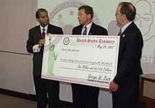 Assistant Secretary Baruah Holding Investment Check--Click for Larger Image.