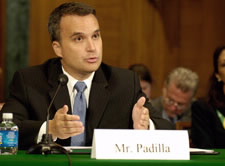 Christopher A. Padilla is pictured at microphone speaking in front of a Congressional committee.