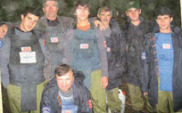 Georgian deminers employed by HALO under a grant from the Office of Weapons Removal and Abatement (PM/WRA) take a break from their demanding work during a rain storm. [Katherine Baker, Office of Weapons Removal and Abatement]
            