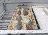 Four large artillery shells that were abandoned but subsequently placed carefully in padded boxes in the back of a truck for transportation and safe destruction at a disposal site. Abandoned ordnance, not just landmines, also pose a hazard to innocent civilians in former conflict zones. [International Trust Fund for Demining and Mine Victims Assistance]            