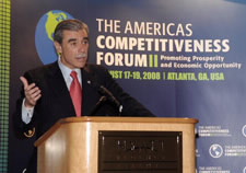 Gutierrez at the podium during reception. The Americas Competitiveness Forum logo is in the background. Click for larger image.