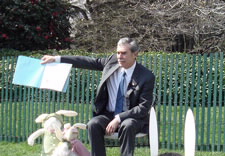 Gutierrez holds a book open on White House lawn. Click for larger image.