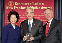 Secretary of Labor Elaine L. Chao (L) and Assistant Secretary of Labor for Disability Employment Policy Roy Grizzard (R) present a 2004 Secretary of Labor's New Freedom Initiative Award to James Wells (center) Vice ChairmanSunTrust Banks, Inc.