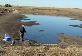 Waste samples being collected from a swine manure storage structure