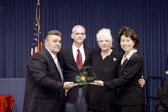 Michael Sacco, President, The Seafarers International Union of North America; Max Hall and Margo Hall-O'Kane (children of Paul Hall); and Secretary of Labor Elaine L. Chao. (DOL Photo)