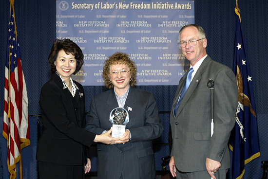 Secretary of Labor Elaine L. Chao and Assistant Secretary of Labor for Disability Employment Policy present a 2003 New Freedom Initiative Award to Joyce A. Bender of Bender and Associates International, Inc.