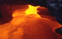 View into skylight of active lava tube on coastal plain of Kilauea Volcano, Hawai`i