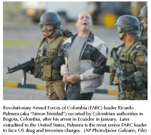 Revolutionary Armed Forces of Colombia [FARC] leader Ricardo Palmera [aka Simon Trinidad] escorted by Colombian authorities in Bogota, Colombia, after his arrest in Ecuador in January. Later extradited to the United States, Palmera is the most senior FARC leader to face U.S. drug and terrorism charges. [AP Photo/Javire Galeano, File]