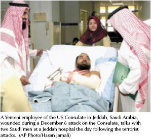 A Yemeni employee of the U.S. Consulate in Jeddah, Saudi Arabia, wounded during a December 6 attack on the Consulate, talks with two Saudi men at a Jeddah hospital the day following the terrorist attacks. [AP Photo/Hasan Jamali]