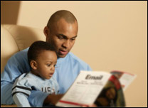 Father reading book to baby boy