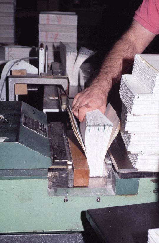 Volumes being nipped, and endsheet folded over.
