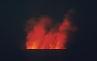 Glow reflected on cloud of steam and gas from eruption at summit of Mauna Loa
