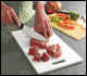 Cutrting raw meat and raw vegetables on separate cutting boards