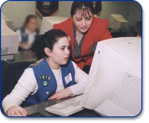 A mentor and mentee discuss results of a computer search.