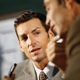 two men talking at table