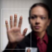 Woman holding her hand up to electronic screen