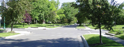 Photo of residential neighborhood showing new sidewalk and curb ramp construction.