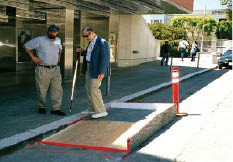 A temporary movable landing and ramp constructed of plywood that can be set in a street curb lane to provide access at a pedestrian detour.  Edge protection is provided by a low curb.