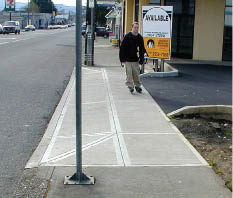 Photo of sidewalk crossing driveway.