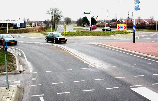 Figure 9.  Photo.  Typical juxtaposed pedestrian and bicycle crossing at a turbo-roundabout.  This photograph depicts an at-grade pedestrian crosswalk on the exit of a double-lane turbo roundabout.  The crosswalk is clearly marked with skip marks for visibility.