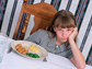 Photo of child with dinner plate before her.