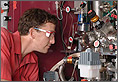 Photo of a researcher inspecting equipment.