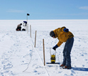 Photo of researchers collecting radar data to document meltwater movement on the Ice Sheet.
