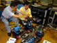 C.S. George Lee and H. Jacky Chang operate mobile robots