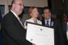 From left to right: USCIS Director Emilio T. González, "Outstanding American by Choice" recipient Marina Beloserkovsky, and Attorney General Alberto Gonzales in New York, NY, Jul. 7, 2006
