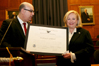 USCIS Director Emilio T. González presents Assistant Secretary Josefina G. Carbonell with the “Outstanding American by Choice” recognition in Washington, DC, Feb. 13, 2007