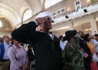 A U.S. serviceman salutes during the Ellis Island Naturalization Ceremony.