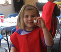 Photo of a student showing off her home-made bouncy ball at The Discovery Museums, Acton, Mass.
