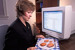 Nutritionist uses a computer to interview survey respondents: Click here for full photo caption.