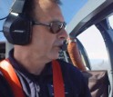 man with headset in cockpit of plane